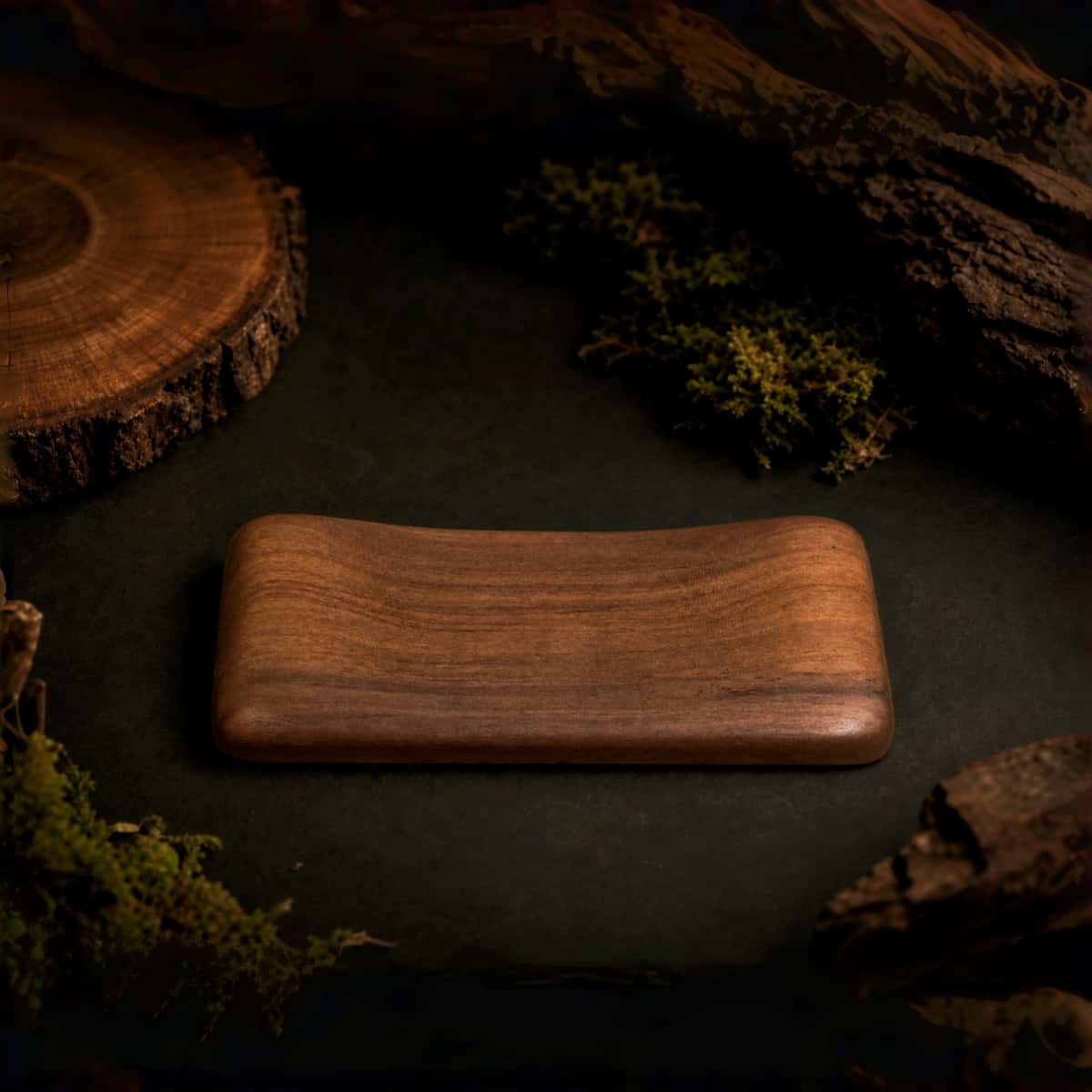 Handcrafted walnut hand rest plain, lifestyle photo with natural foliage background