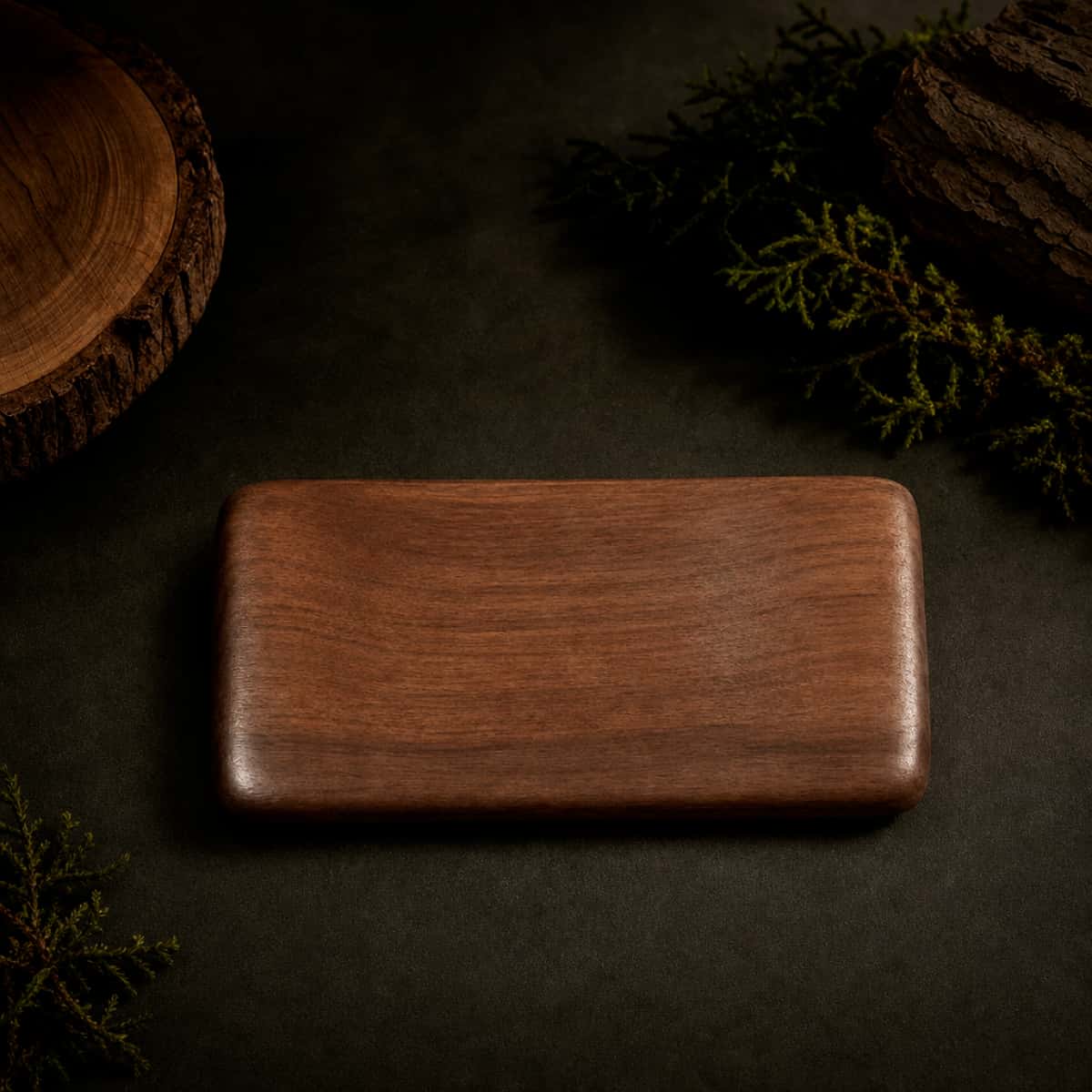 HAVNMADE walnut hand rest top view, natural wood grain on dark background