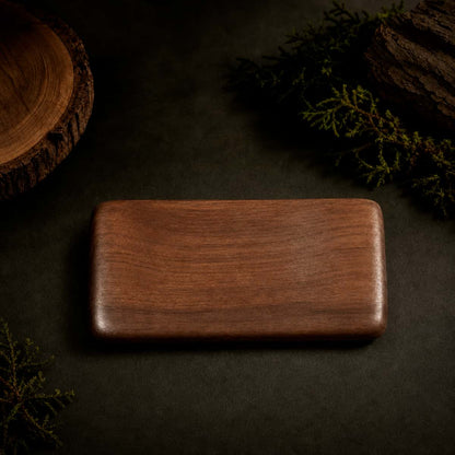 HAVNMADE walnut hand rest top view, natural wood grain on dark background