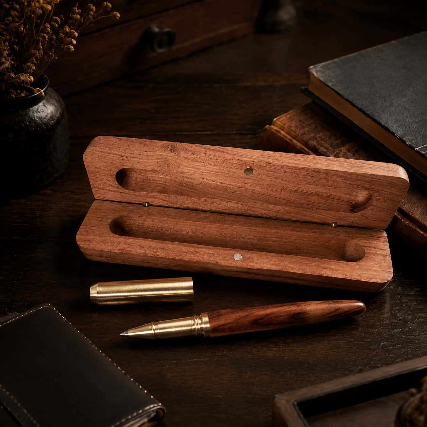 Wooden pen gift set with brass ballpoint pen beside open wood case, desk lifestyle